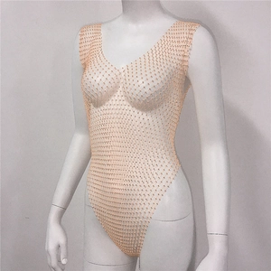 Detail of light orange fishnet bodysuit with sparkling rhinestones and high-cut leg