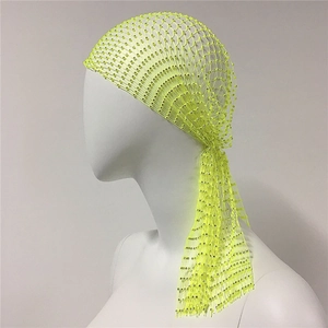 Close-up of neon yellow fishnet headscarf with glittering rhinestones for party wear