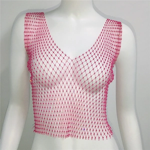 Détail du haut en maille rose rouge avec des perles de cristal en motif de losange