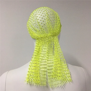 Detailed view of neon green rhinestone fishnet headband with intricate mesh pattern