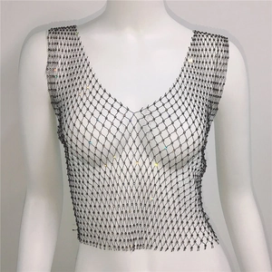 Detail of black rhinestone mesh crop top featuring shimmering crystals on net structure