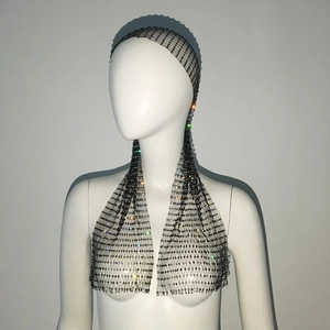 Detailed view of black rhinestone fishnet headpiece with sparkling crystals on mesh fabric