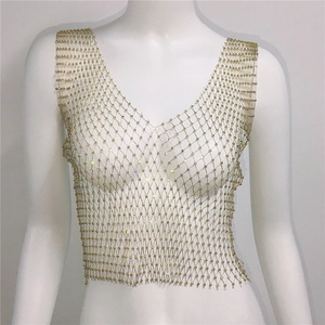 Détail du gilet en maille métallique dorée avec strass scintillants et col en V chic