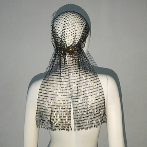 Close-up of sparkling rhinestones on black mesh fabric with a fringed tassel effect