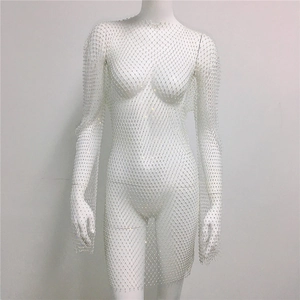 Detailed view of silver rhinestones on white mesh fabric of a long-sleeved dress