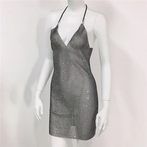 Detail of silver rhinestone mesh dress featuring a deep V-neck and halter straps