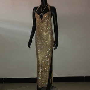 Macro detail of sparkling gold rhinestone fabric and side slit on halter neck dress