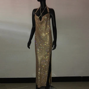 Detail of gold rhinestone halter dress featuring deep V-neck and sparkling side slit