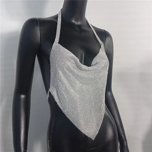 Detailed view of silver rhinestone halter top with glittering metal mesh and backless design