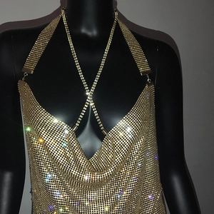 Detail of gold metal mesh sequin top with rhinestone criss-cross halter neck straps