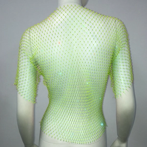 Detailed macro view of vibrant neon green mesh top with sparkling iridescent rhinestones