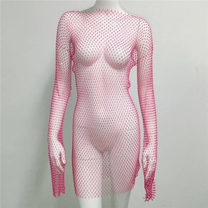 Detail of pink long sleeve mesh dress featuring shimmering crystals and net texture