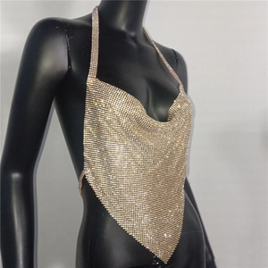 Macro detail of champagne gold rhinestone mesh halter top with elegant draped neckline