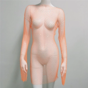 Detail of orange mesh dress with sparkling rhinestones and see-through fabric texture