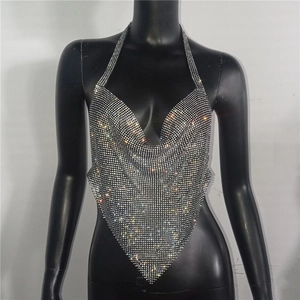 Macro detail of silver rhinestone crop top with V-neckline and shiny metallic texture