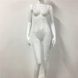 Close-up of white mesh mini dress with dense rhinestone embellishments and sheer texture