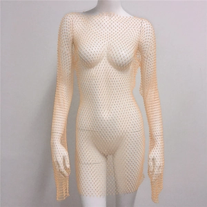 Detail of sheer mesh dress with rhinestones on a flesh-colored long sleeve mini dress