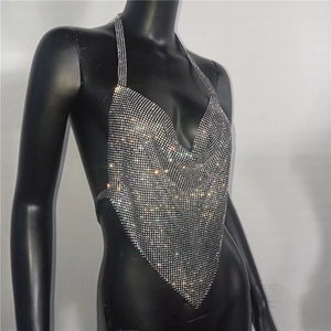 Detailed close-up of sparkling silver rhinestone halter top with plunging neckline