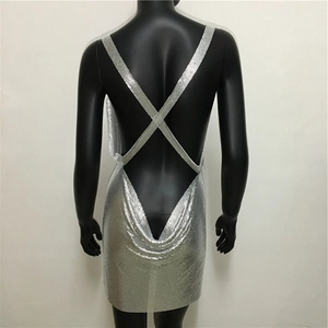 Macro view of silver sequin metal mesh fabric and cross back strap detail on mini dress