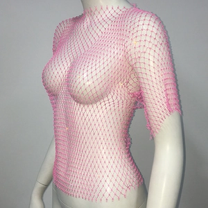 Detail of pink mesh crop top with shimmering beads and hollow fishnet texture