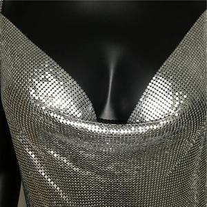 Detailed macro view of sparkling silver metal mesh fabric with deep V-neckline style