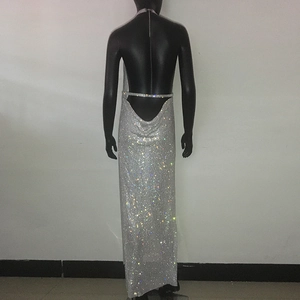 Detail of silver sequin evening dress showing deep V backless design and halter neck strap