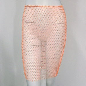 Détail de jupe en maille orange avec strass brillants sur mannequin blanc