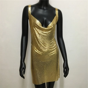 Detail showing the gold chainmail metal sequins and draped deep V-neckline of the dress