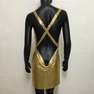 Detail of gold sequin dress featuring an open back design with crisscross X-straps
