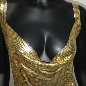 Detail shot of golden metallic sequins joined by small rings on a sexy party camisole