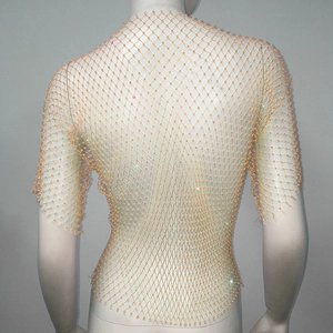 Detailed back view of orange fishnet top with shimmering rhinestones and beads