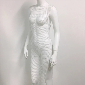 Detailed close-up of white mesh rhinestone dress with side slit and sparkling crystals