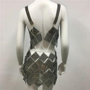 Macro detail of sexy rhinestone patchwork mini dress with diamond chain metal connections