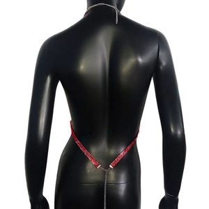 Detail of red rhinestone body chain with silver crisscross back straps on a mannequin