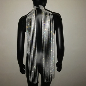 Detailed view of silver rhinestone body chain with long shimmering tassels on a model