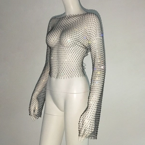 Detailed close-up of a black fishnet long sleeve top with shiny rhinestones on a model