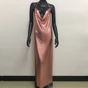 Macro shot of rose gold metal mesh fabric and delicate chain straps of the evening dress