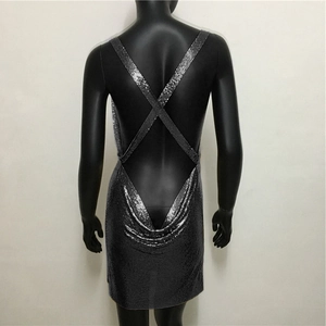 Detail of silver metallic sequin mini dress featuring backless design with cross straps