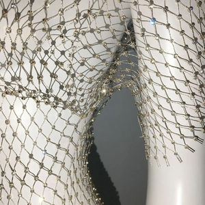 Macro detail of champagne gold rhinestone mesh top with sparkling crystal diamond accents