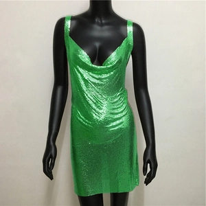 Detail view of sparkly green metal mesh fabric and sequin texture on mini party dress