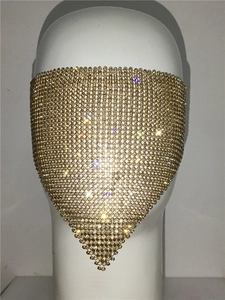 Detail of trendy gold mesh face mask featuring sparkling rhinestones in a triangle design