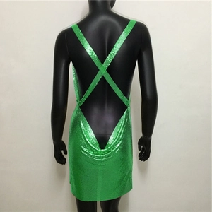 Detailed back view of emerald green sequin mini dress with crisscross straps on mannequin