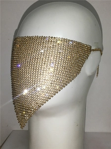 Detail of gold metal mesh veil with sparkling rhinestones on a white mannequin head