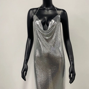 Macro detail of the silver metallic mesh fabric and halter neckline on a party dress