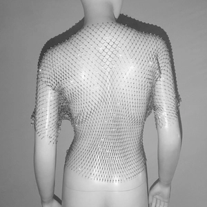 Close-up of sparkling rhinestone mesh top with silver chains for music festivals