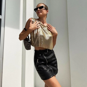 Sexy gold sequin metal crop top with black leather skirt for music festivals