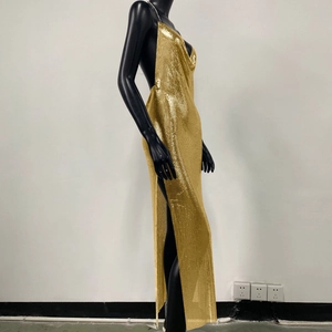 Detail of gold metal sequin dress featuring side slit and backless design on black mannequin