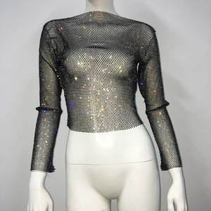 Detail of black mesh crop top with shimmering colorful rhinestones on a mannequin