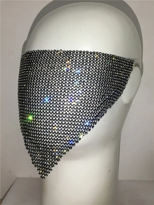 Close-up of sparkling rhinestone mesh face mask with silver crystals on black grid