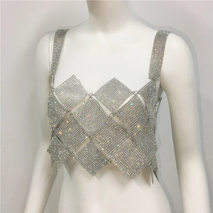 Detailed macro view of shimmering silver rhinestone mesh panel with intricate diamond cutouts
